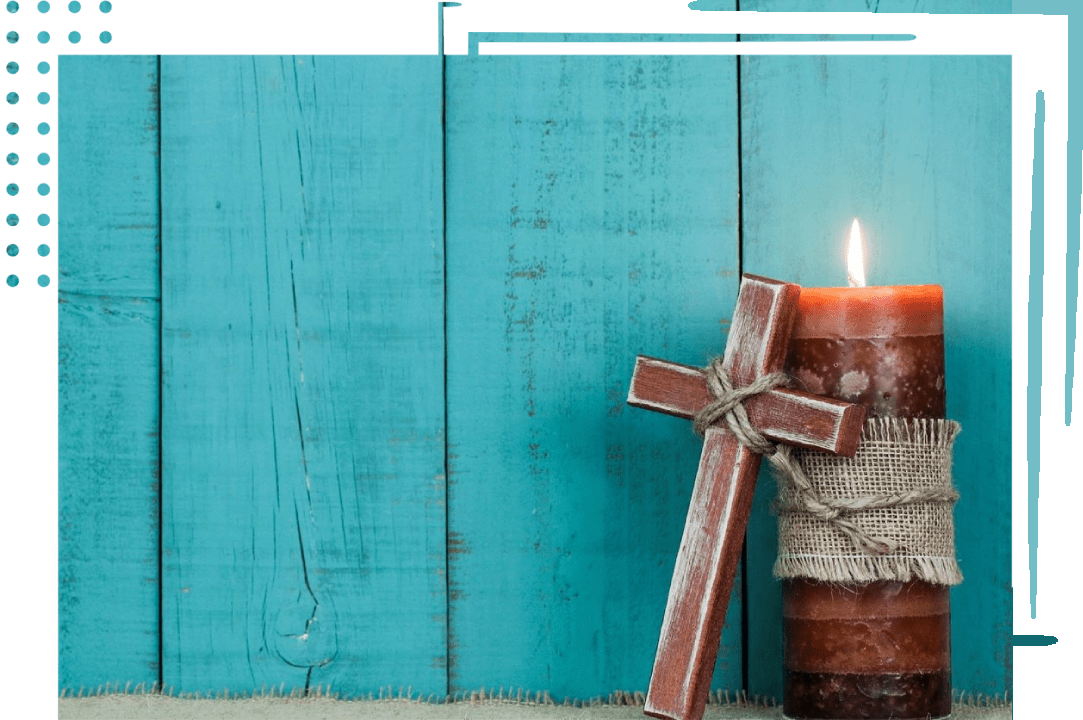 A candle and cross are on the ground.